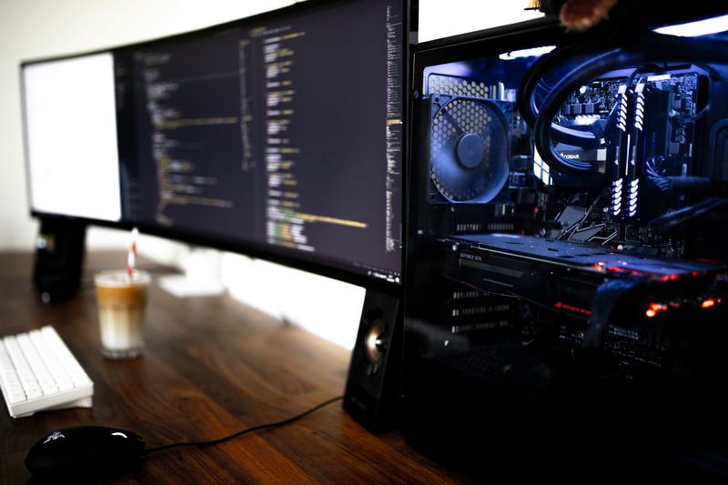 Developer workstation with monitors showing source code